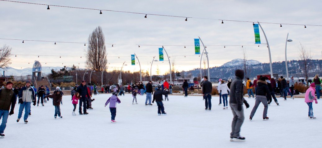 people having fun ice skating at stuart park kelowna in winter